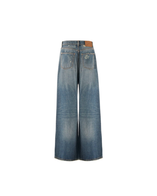 Jeans wide leg con lavaggio scolorito e lacerazione